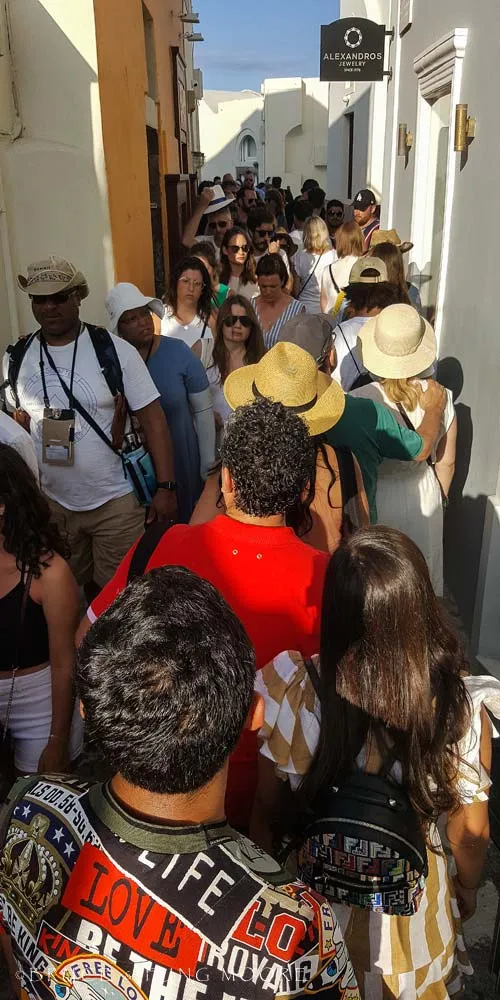Oia evening crowds in narrow walkway
